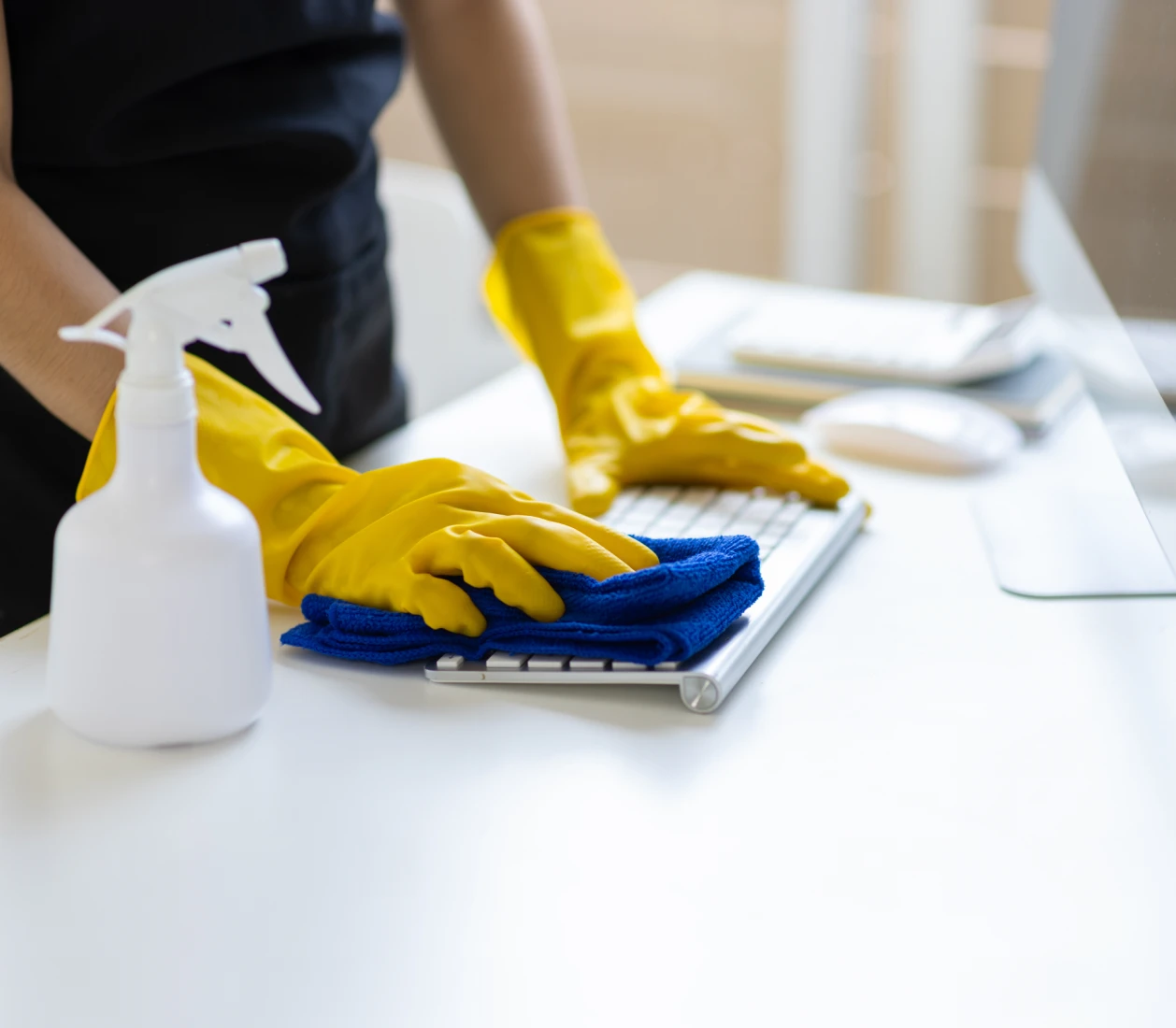 Cleaning keyboard with gloves and cloth